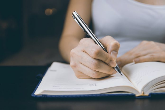 pexels-photo-834897 photo of person writing on notebook